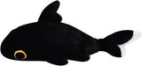 Black plush shark toy with a gold eye on a white background