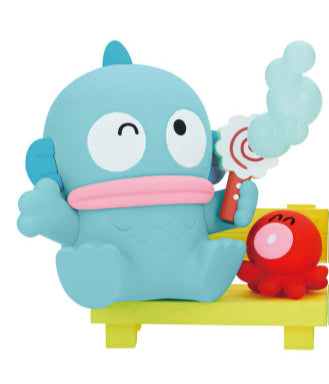 Toy figure of a blue creature with a red creature on a yellow platform against a white background