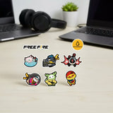 Free Fire Booyah! sticker set featuring colourful game-inspired character designs, displayed on a holographic package, desk, and smartphone.