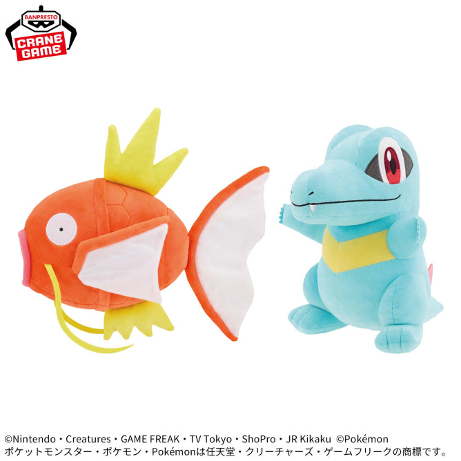 Banpresto Pokémon plush toys featuring orange Magikarp with a yellow crown-like fin and large white fins, alongside blue Totodile with a yellow belly and red eyes.