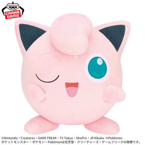 Banpresto Pokémon Jigglypuff plush toy featuring a large, round pink body, one winking eye, a curled tuft of hair, and an adorable smiling expression.