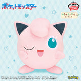 Banpresto Pokémon Jigglypuff plush toy featuring a large, round pink body, one winking eye, a curled tuft of hair, and an adorable smiling expression.
