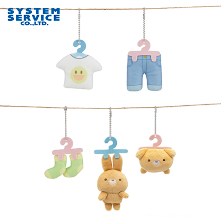 Plush toys resembling baby clothes and accessories hanging on a line with 'System Service Co., Ltd.' branding.
